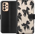 Pikkukuva 1 / 3: Yhteensopiva Lompakkokotelo Samsung Galaxy A53 5G Mustat rusetit beigen taustan päällä, elegantti ajaton design pehmeillä kontrasteilla ja ylellisell