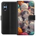 Pikkukuva 1 / 3: Yhteensopiva Lompakkokotelo Sony Xperia 10 VI Nukkuvia kissanpentuja kerällä värikkäiden lankakerien keskellä pehmeässä kuvituksessa