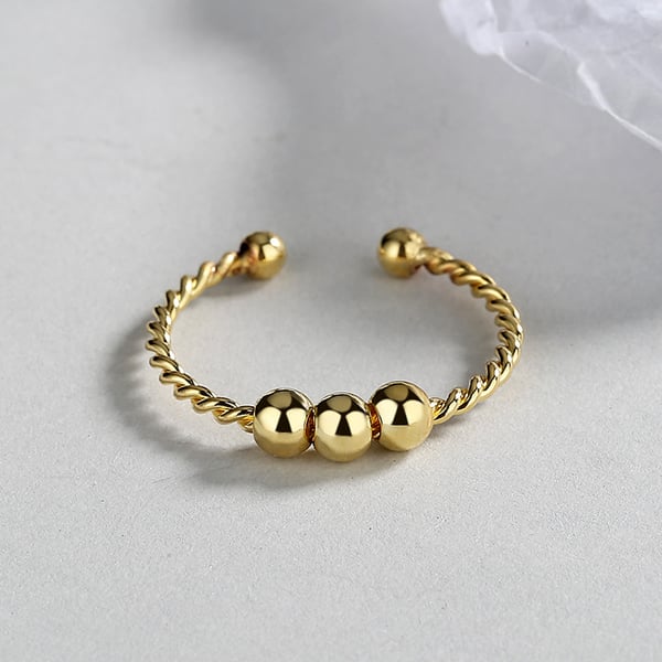Justerbar anti-stress ring med drejelige perler Gold