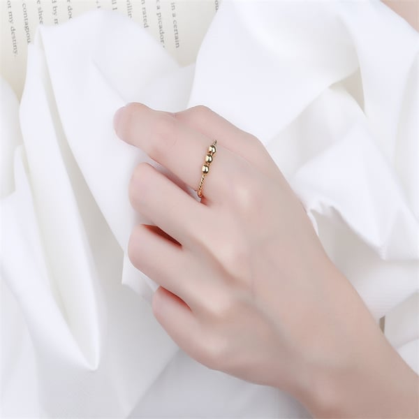 Justerbar anti-stress ring med drejelige perler Gold