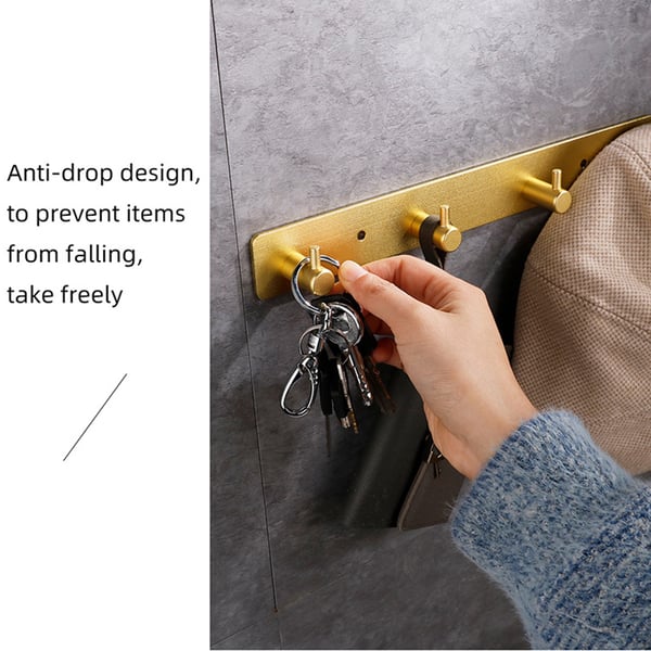 Veggmontert klesstativ i gull med 5 kroker - Installasjon uten boring