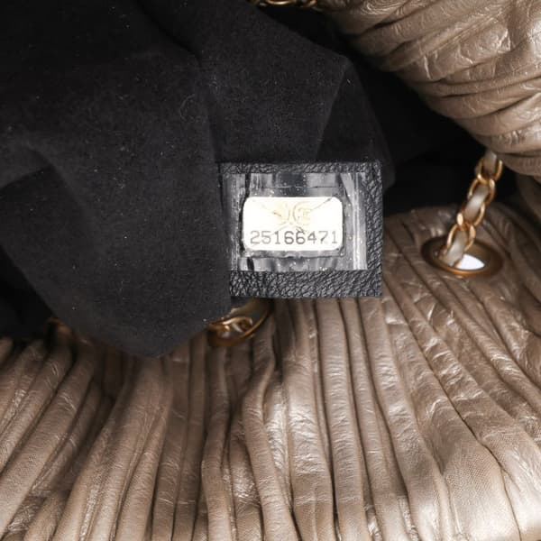 Pre-owned Chanel Medium Metallic Calfskin Coco Pleats Drawstring Backpack Gold