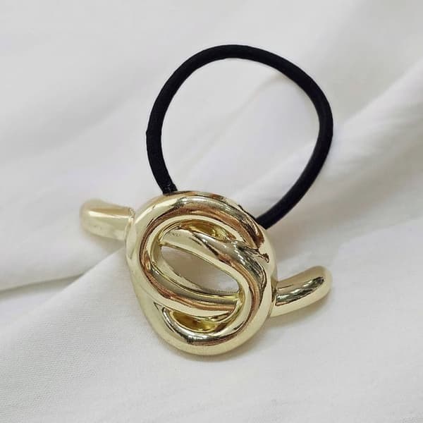 Elastisk fantasi för hår, skulpturell chic knut i guld