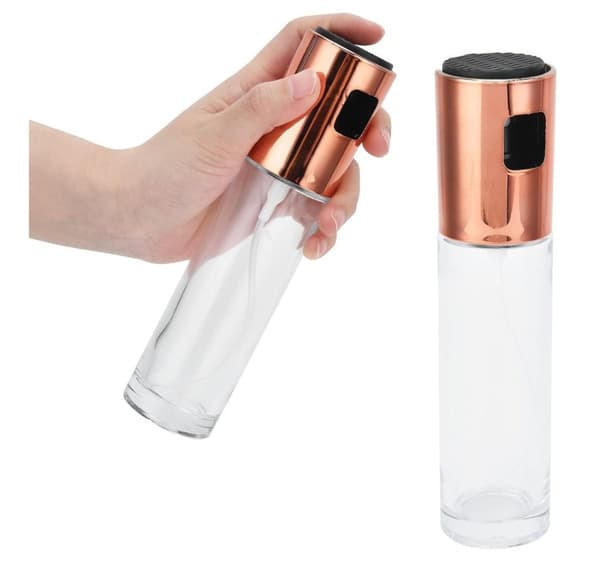 Glasflaska med en olivolja spruta och ett kopparlock