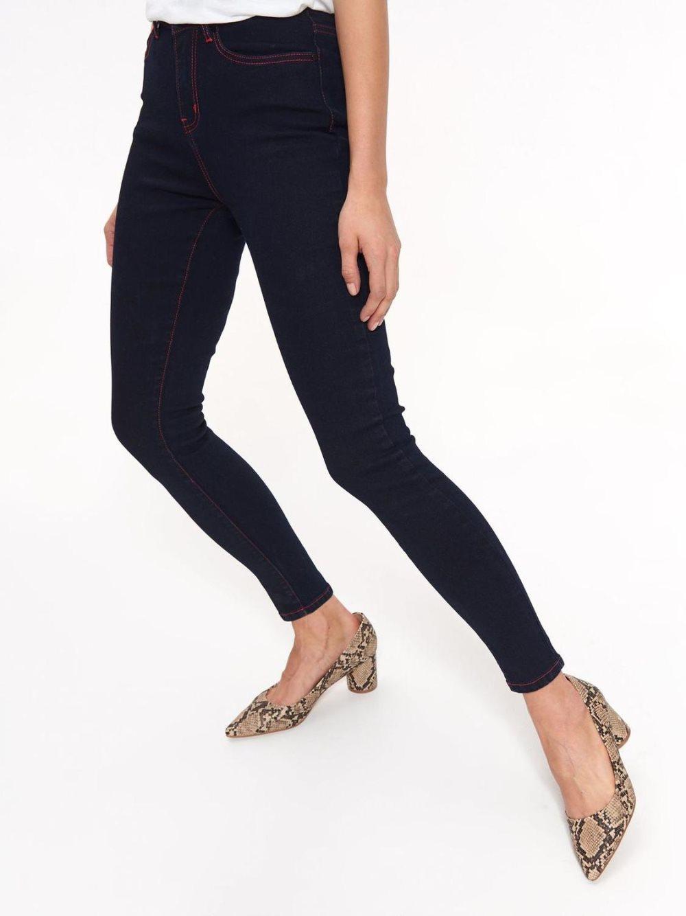 With denim jeans with red stitching