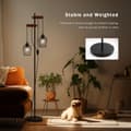 Miniatyrbillede 6 af 9: EMKE industriel gulvlampe – Dobbelt E27-fod, sort jernlampeskærm, brændt træfinish, 1,5 m høj