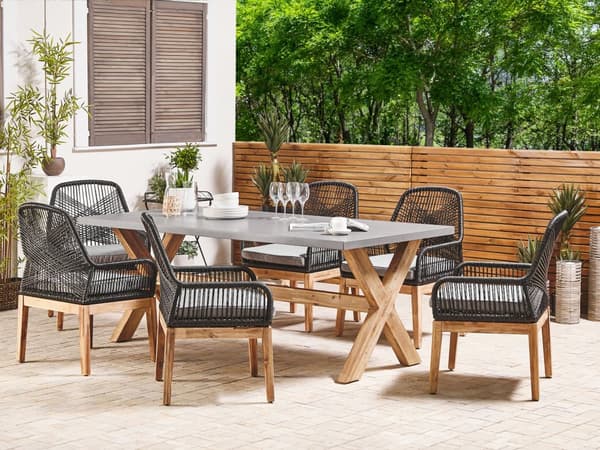 Utendørs spisegruppe Grå Svart Bord i betong 6 flettede stoler Sitteputer Moderne design Hagemøbler
