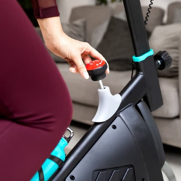 Cecotec Indoor bike with 10-kg flywheel, hand resistance, LCD console, device holder, bottle, and bottle holder.
