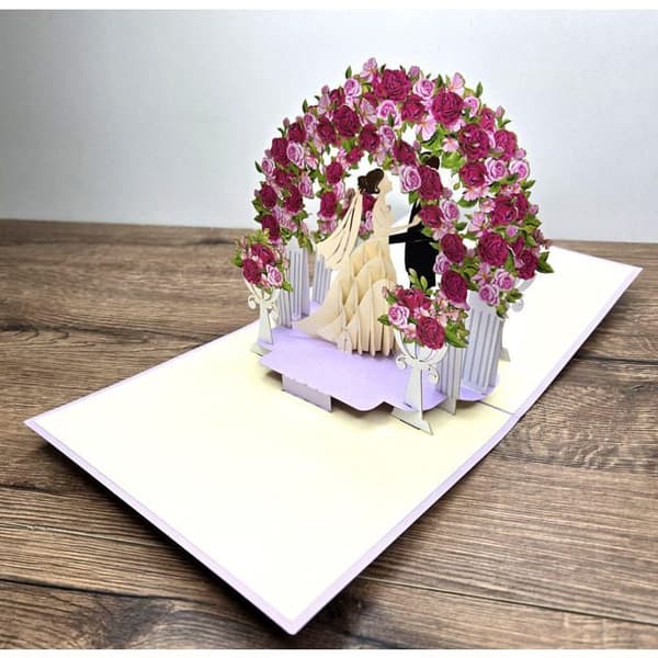 Bröllopskort i 3D med rosbog och brudparets figurer