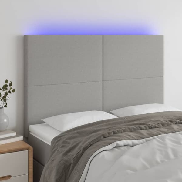 sengegavl med LED-lys 144x5x118/128 cm stof lysegrå