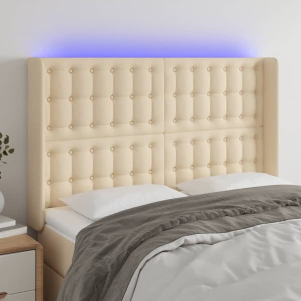 sengegavl med LED-lys 147x16x118/128 cm stof cremefarvet