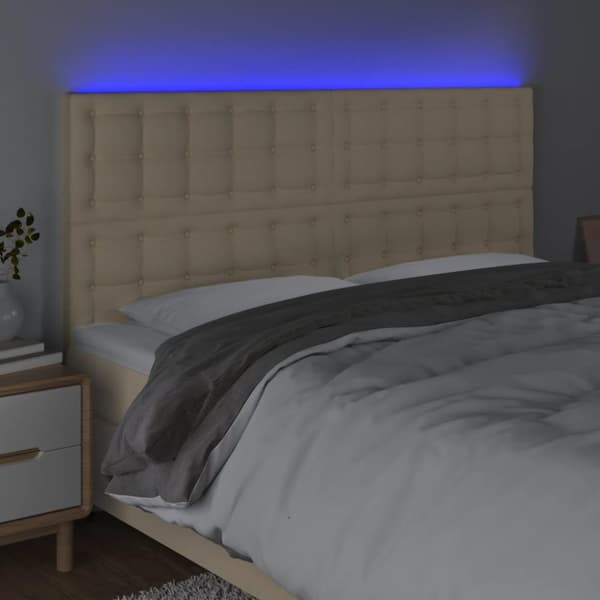sengegavl med LED-lys 180x5x118/128 cm stof cremefarvet