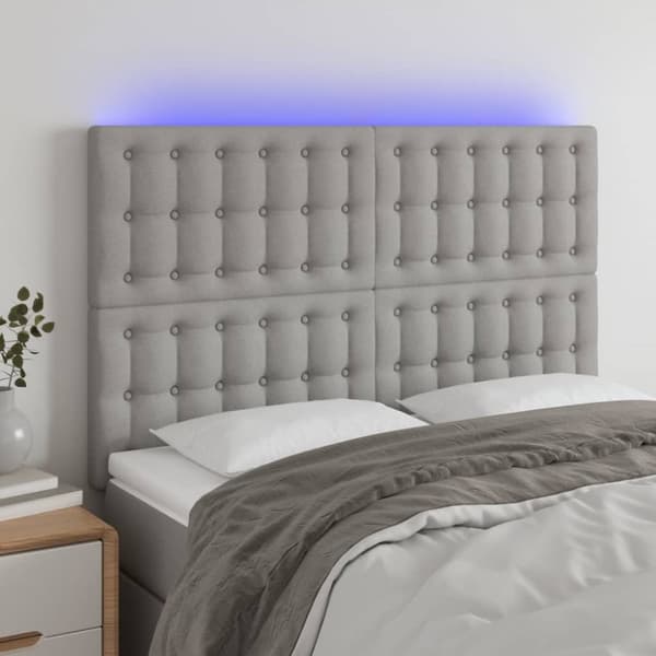sengegavl med LED-lys 144x5x118/128 cm stof lysegrå