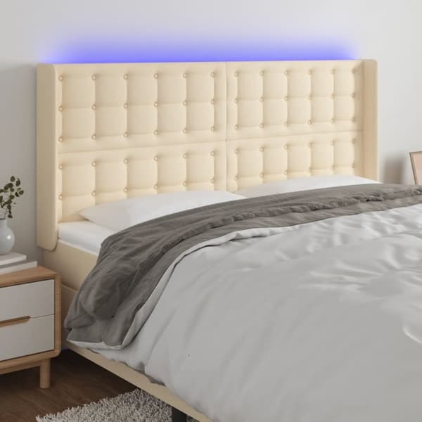 sengegavl med LED-lys 183x16x118/128 cm stof cremefarvet