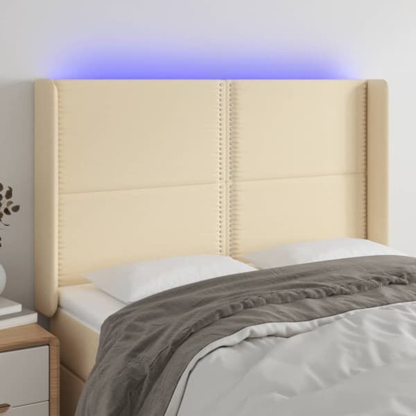 sengegavl med LED-lys 147x16x118/128 cm stof cremefarvet