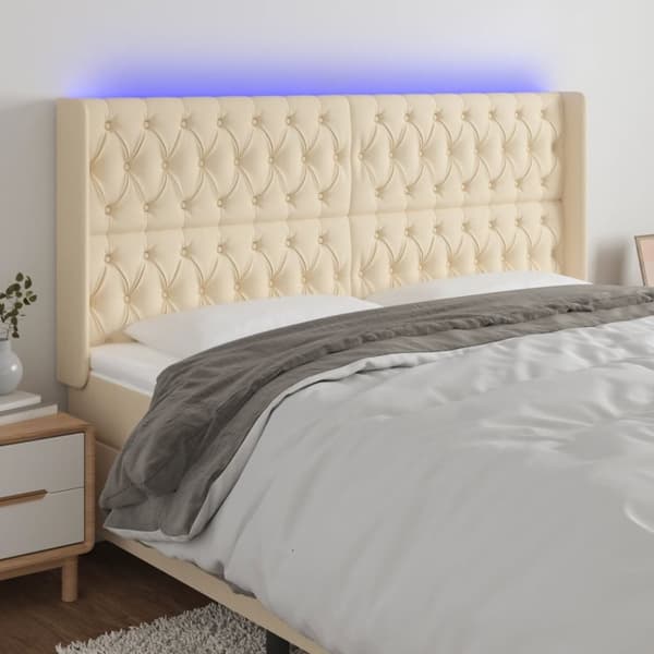 sengegavl med LED-lys 203x16x118/128 cm stof cremefarvet