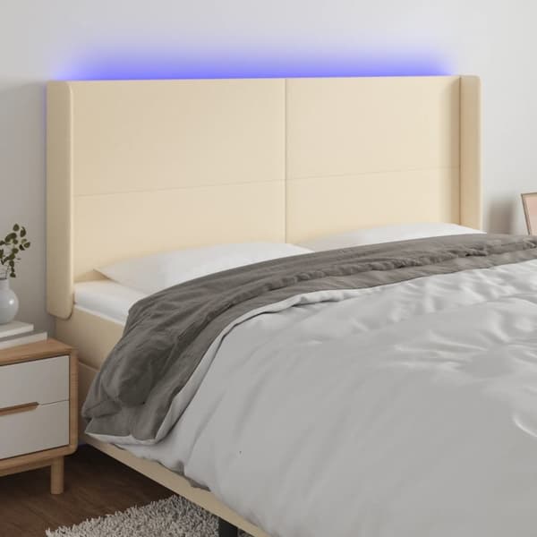 sengegavl med LED-lys 163x16x118/128 cm stof cremefarvet