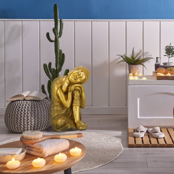 Buddha-statue med hode på kne