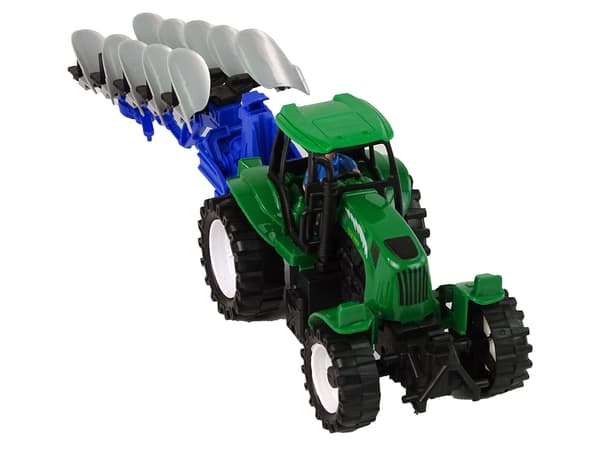 Grön traktor med ploggård