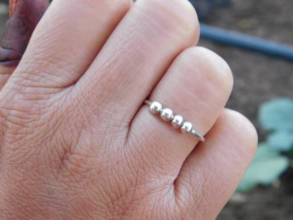 INF Justerbar antistressring med roterbare perler i platinagull