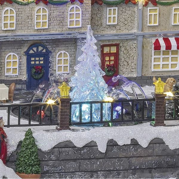Livlig och ljus jultomteby i centrumfontän