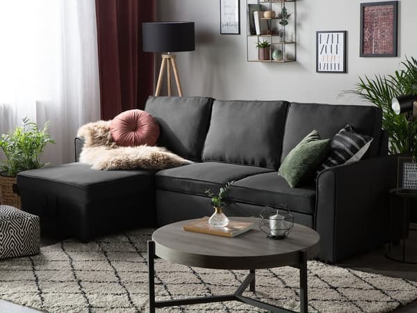 Hjørnesovesofa i svart stoff med polstring og oppbevaringsseng i høyrevendt retning