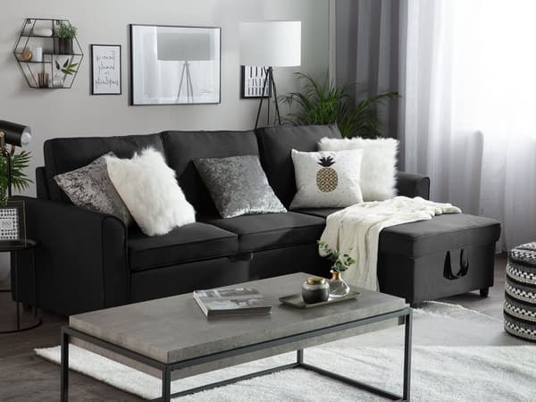 Hjørnesovesofa i svart stoff med venstrevendt polstring og oppbevaringsseng