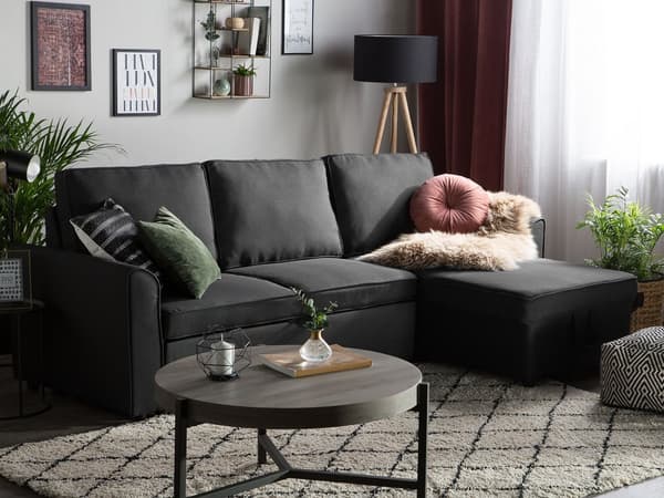 Hjørnesovesofa i svart stoff med venstrevendt polstring og oppbevaringsseng