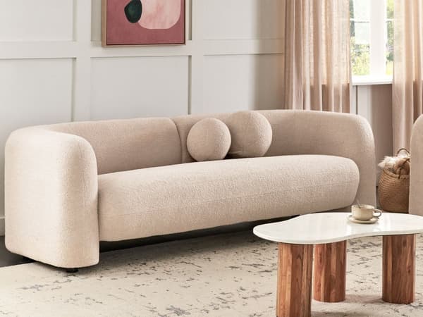 Sohva beige bukleekangas verhoiltu puu kolmelle kaareva pyöreät koristetyynyt moderni glamour tyyli