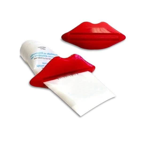 Tandkräm tub squeezer i form av rosa röda läppar ovanlig design hem deco objekt.