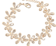 Armband i guldfärg, blommor på rad
